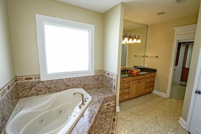 bathroom featuring vanity, a relaxing tiled tub, and tile patterned flooring