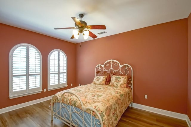 bedroom with hardwood / wood-style flooring and ceiling fan