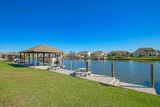 dock area featuring a water view and a lawn