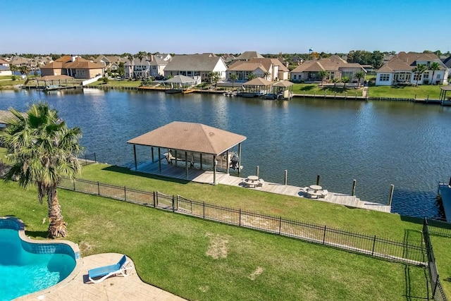 view of dock featuring a lawn, a water view, and a fenced in pool