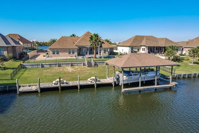 view of dock with a yard and a water view