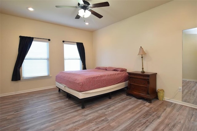 bedroom with wood-type flooring and ceiling fan