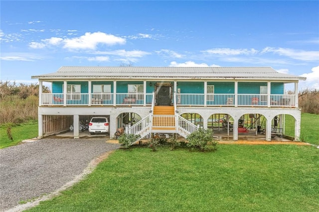 view of front of property featuring a carport, a front yard, and a porch