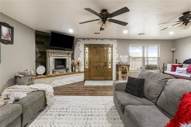 living room featuring hardwood / wood-style flooring and ceiling fan