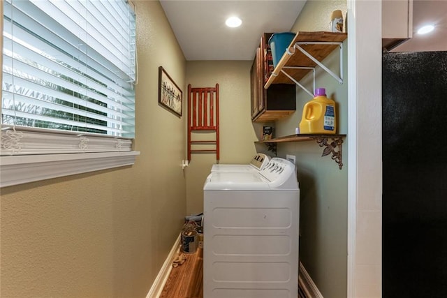 laundry room with cabinets, independent washer and dryer, and hardwood / wood-style floors