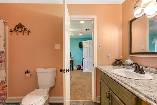 bathroom with vanity, toilet, and tile patterned floors