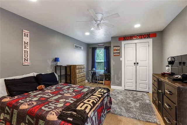 carpeted bedroom featuring a closet and ceiling fan