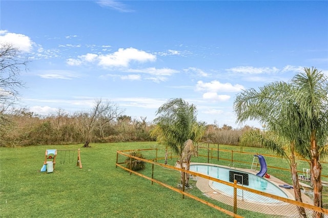 exterior space featuring a lawn and a pool