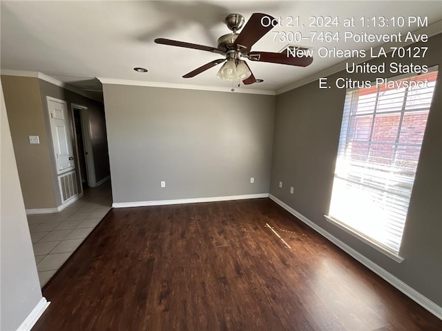 empty room with ornamental molding, hardwood / wood-style flooring, and ceiling fan