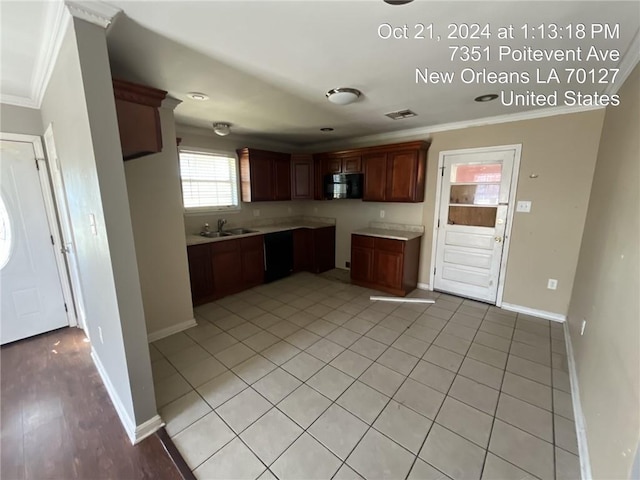 kitchen featuring ornamental molding, black appliances, light tile patterned flooring, and sink