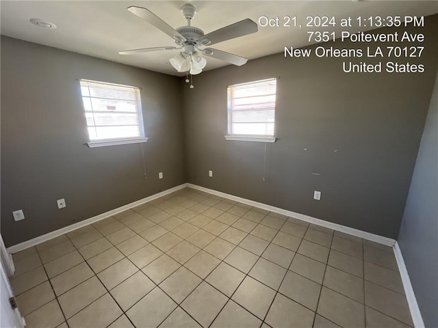 tiled empty room with a healthy amount of sunlight and ceiling fan