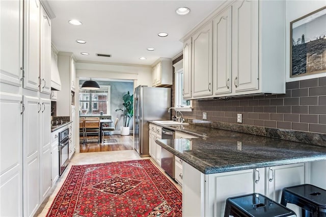 kitchen with recessed lighting, white cabinetry, and stainless steel appliances