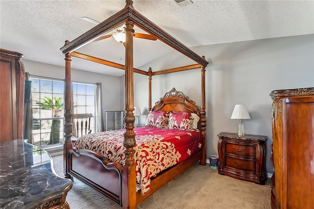 carpeted bedroom featuring ceiling fan, a textured ceiling, and vaulted ceiling