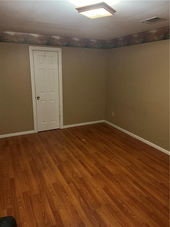 unfurnished room with wood-type flooring