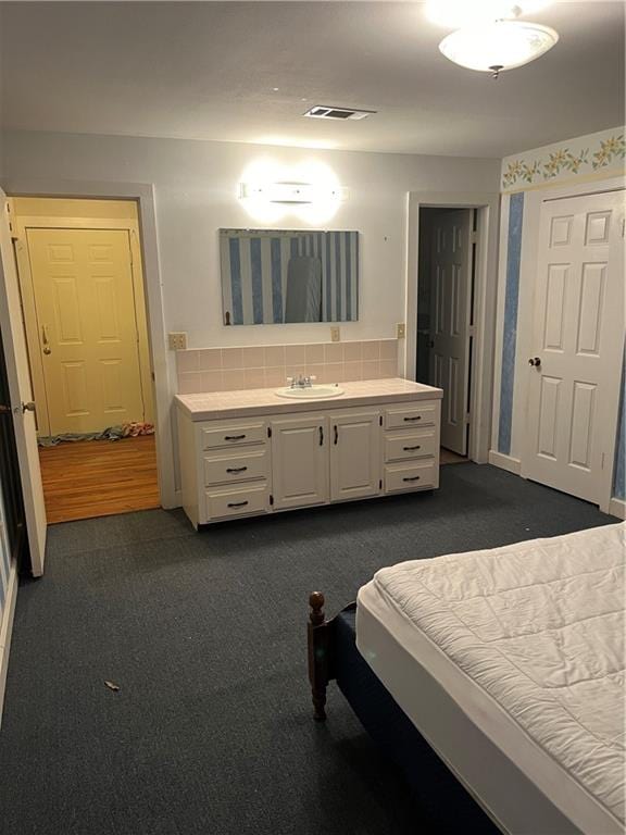 carpeted bedroom with sink