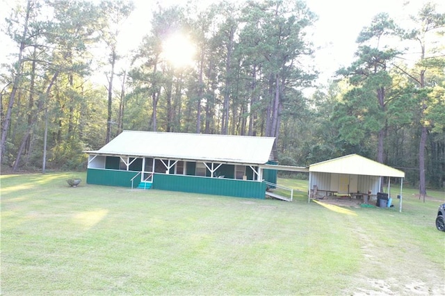 view of front facade with a front lawn and a carport