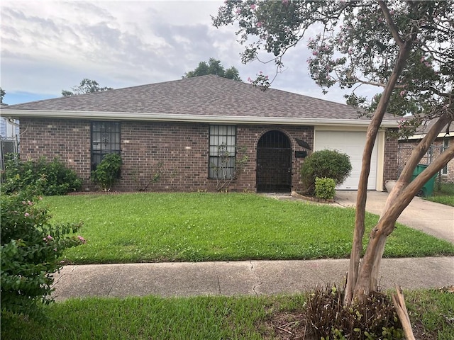 single story home featuring a front lawn and a garage