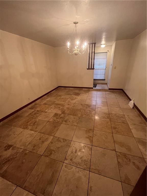 unfurnished room featuring a notable chandelier