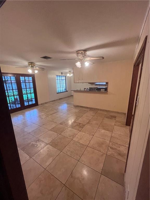 interior space with ceiling fan