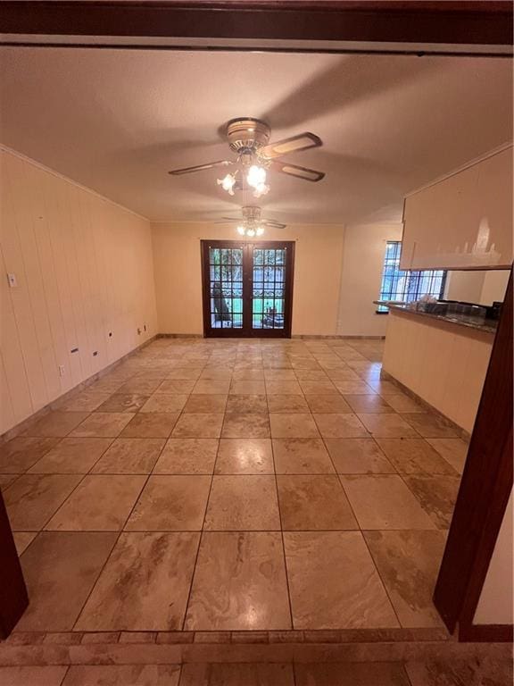 empty room with french doors, light tile patterned flooring, and ceiling fan