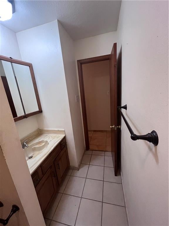 bathroom featuring vanity, a textured ceiling, and tile patterned flooring