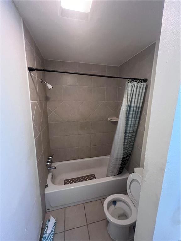 bathroom featuring shower / bath combo, toilet, and tile patterned flooring