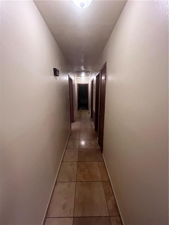 corridor with light tile patterned floors