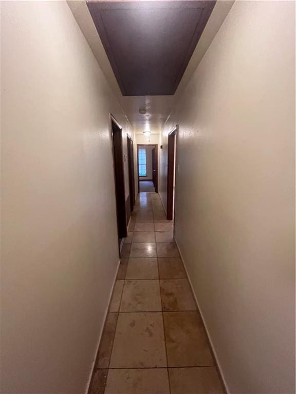 corridor featuring light tile patterned flooring