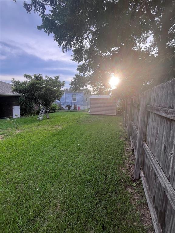 yard at dusk featuring a shed