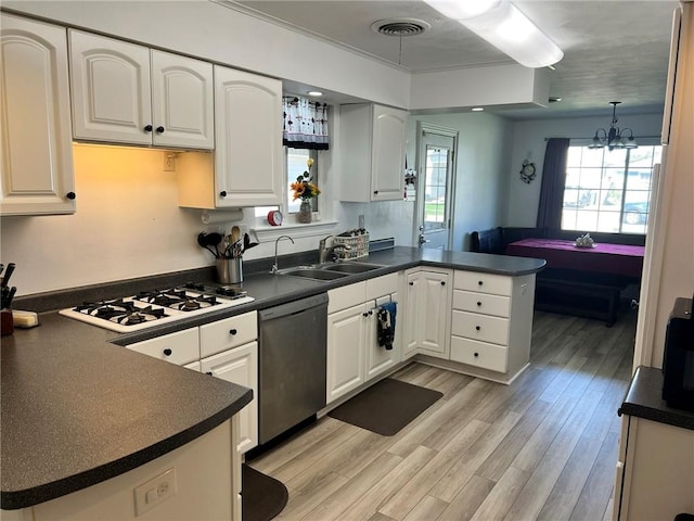 kitchen with dishwasher, kitchen peninsula, pendant lighting, light wood-type flooring, and white cabinets