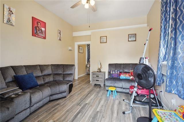 living room featuring ceiling fan and hardwood / wood-style floors