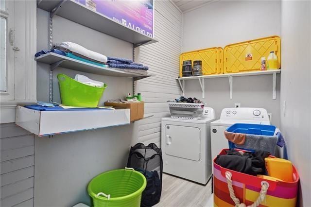 washroom featuring light hardwood / wood-style flooring and washing machine and dryer