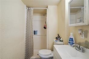 bathroom with vanity, toilet, and a shower with curtain