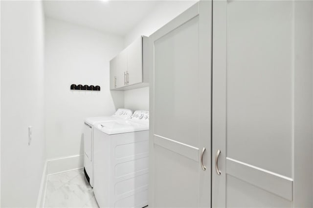 laundry area with cabinets and washing machine and dryer