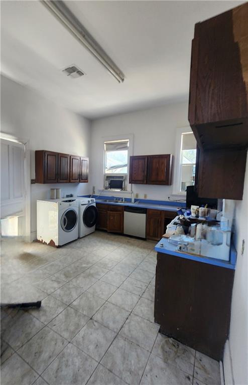 kitchen featuring dishwasher and washing machine and dryer