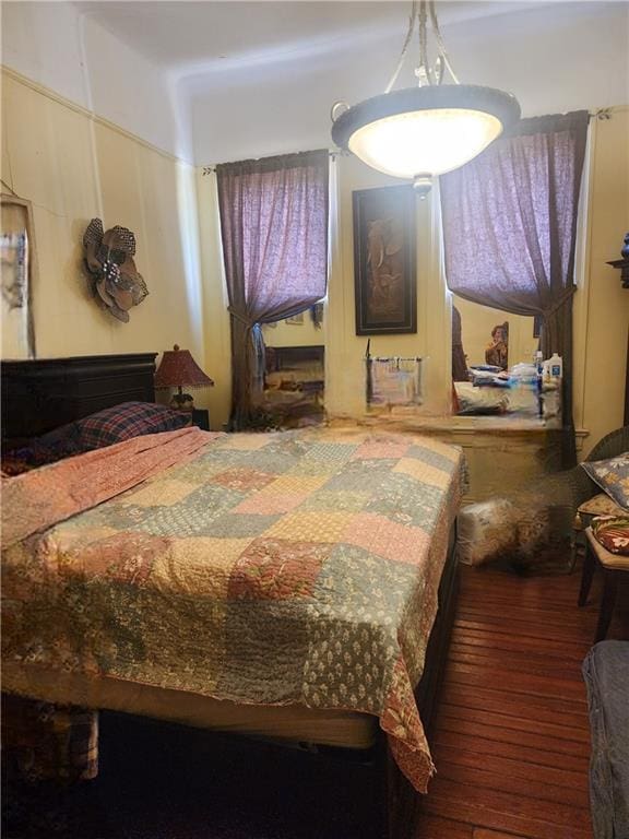 bedroom with dark wood-type flooring