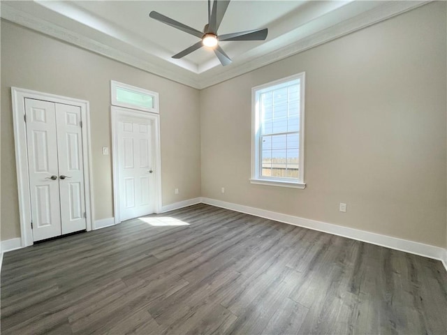 unfurnished bedroom with ceiling fan and dark hardwood / wood-style flooring