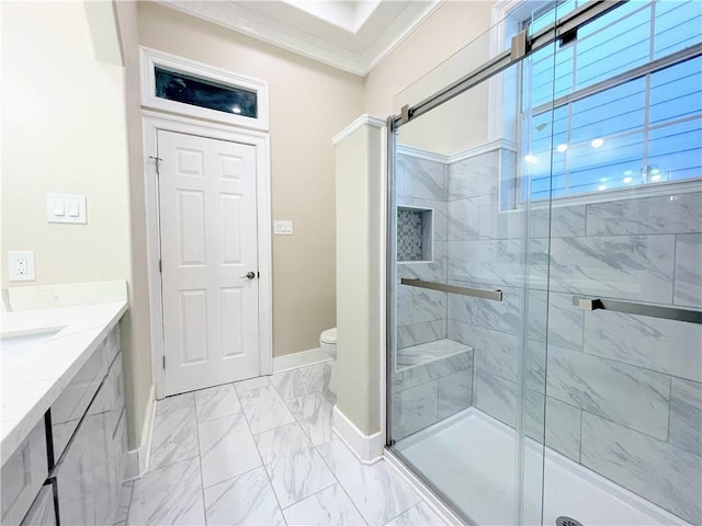 bathroom with a shower with door, vanity, toilet, and crown molding