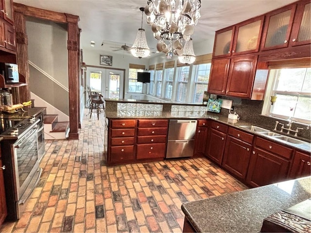 246 Cypress St, Independence, LA 70443 - kitchen featuring dark brown cabinets, a sink, stainless steel appliances, a peninsula, and tasteful backsplash