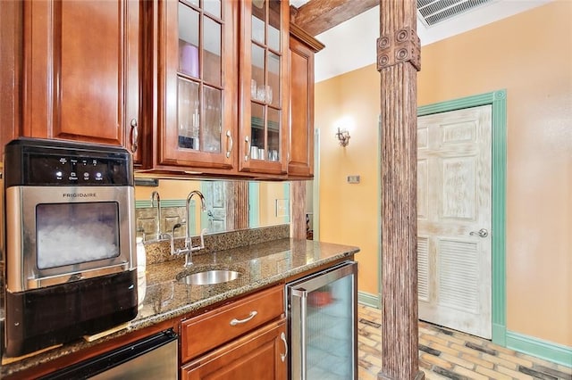 bar featuring dishwasher, beamed ceiling, dark stone counters, wine cooler, and sink