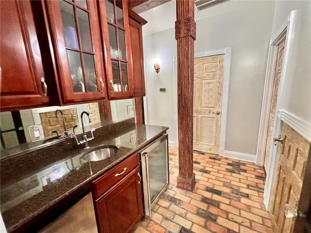 246 Cypress St, Independence, LA 70443 - bar with decorative columns, dishwasher, a sink, baseboards, and brick floor