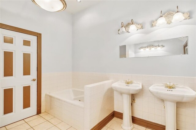 bathroom with tile patterned flooring and tiled tub