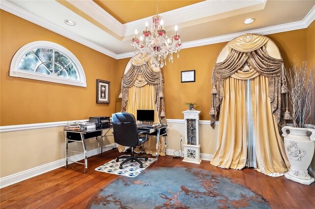 home office featuring wood-type flooring, a tray ceiling, and crown molding