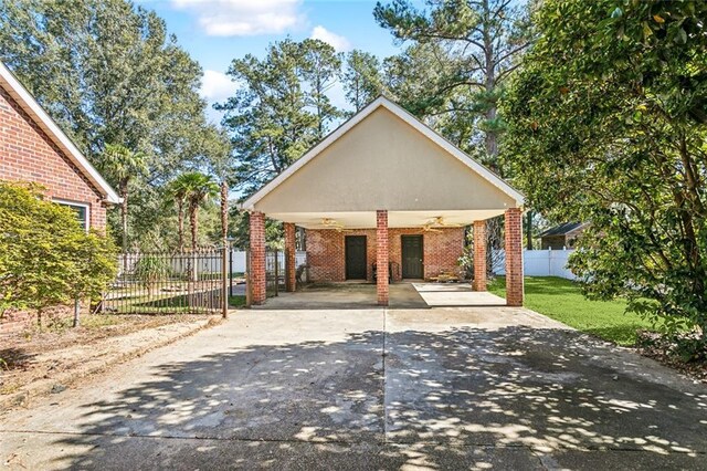 246 Cypress St, Independence, LA 70443 - view of front of property with a front yard, brick siding, a ceiling fan, driveway, and a carport