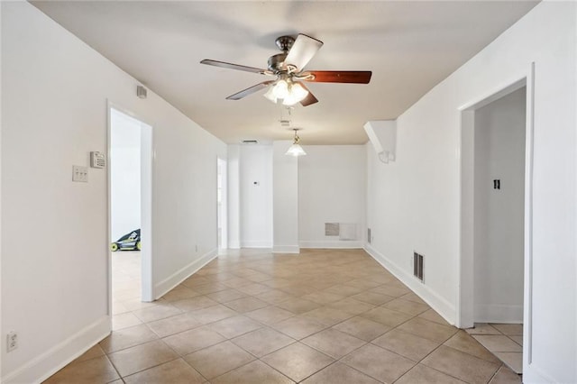 unfurnished room featuring light tile patterned floors and ceiling fan