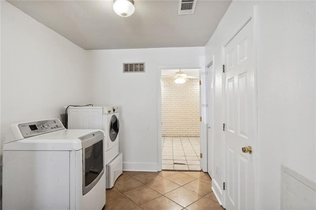 laundry area with washer and dryer, light tile patterned floors, and ceiling fan