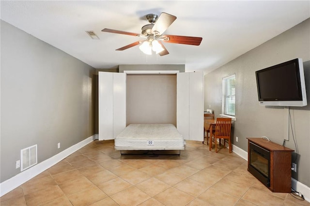 bedroom featuring light tile patterned floors and ceiling fan