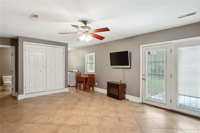 interior space with ceiling fan and light tile patterned floors