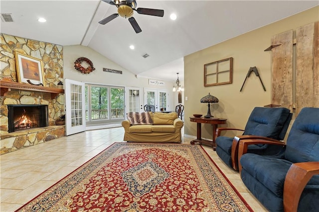 living room with a fireplace, light tile patterned floors, ceiling fan with notable chandelier, and high vaulted ceiling