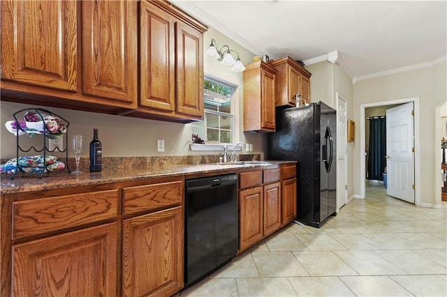 kitchen with dark stone counters, black appliances, crown molding, sink, and light tile patterned floors